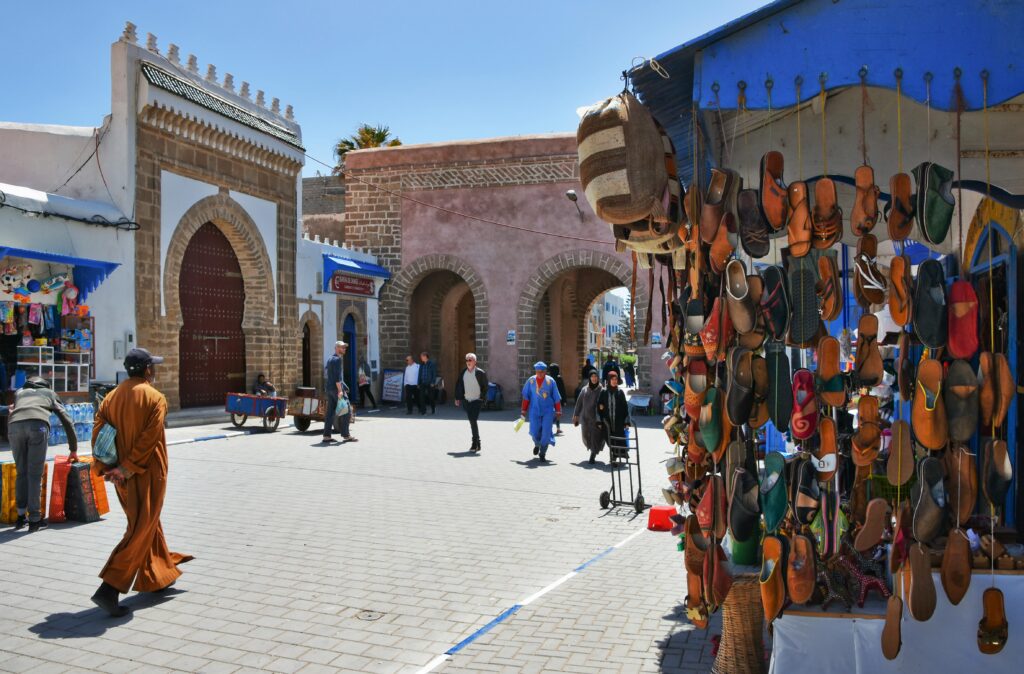 Essaouira Unveiled: A Coastal Odyssey - Day Trip from Marrakech to the Ancient Mogador City 3 Explore the bustling street market of Essaouira, Morocco with local crafts and vendors.