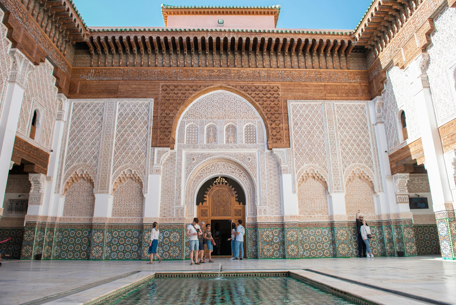 A group of people standing around a pool in a building, casablanca tour