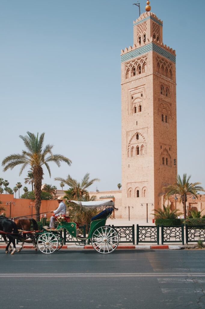 a horse drawn carriage in front of a tall tower, what to wear in morocco