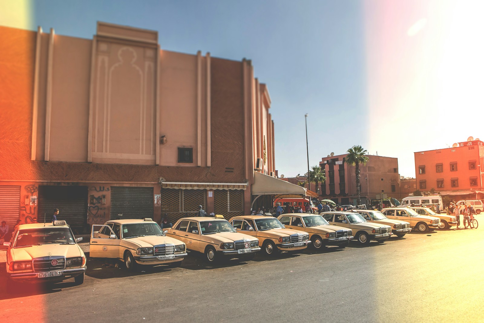 parked vehicles outside brown building during daytime