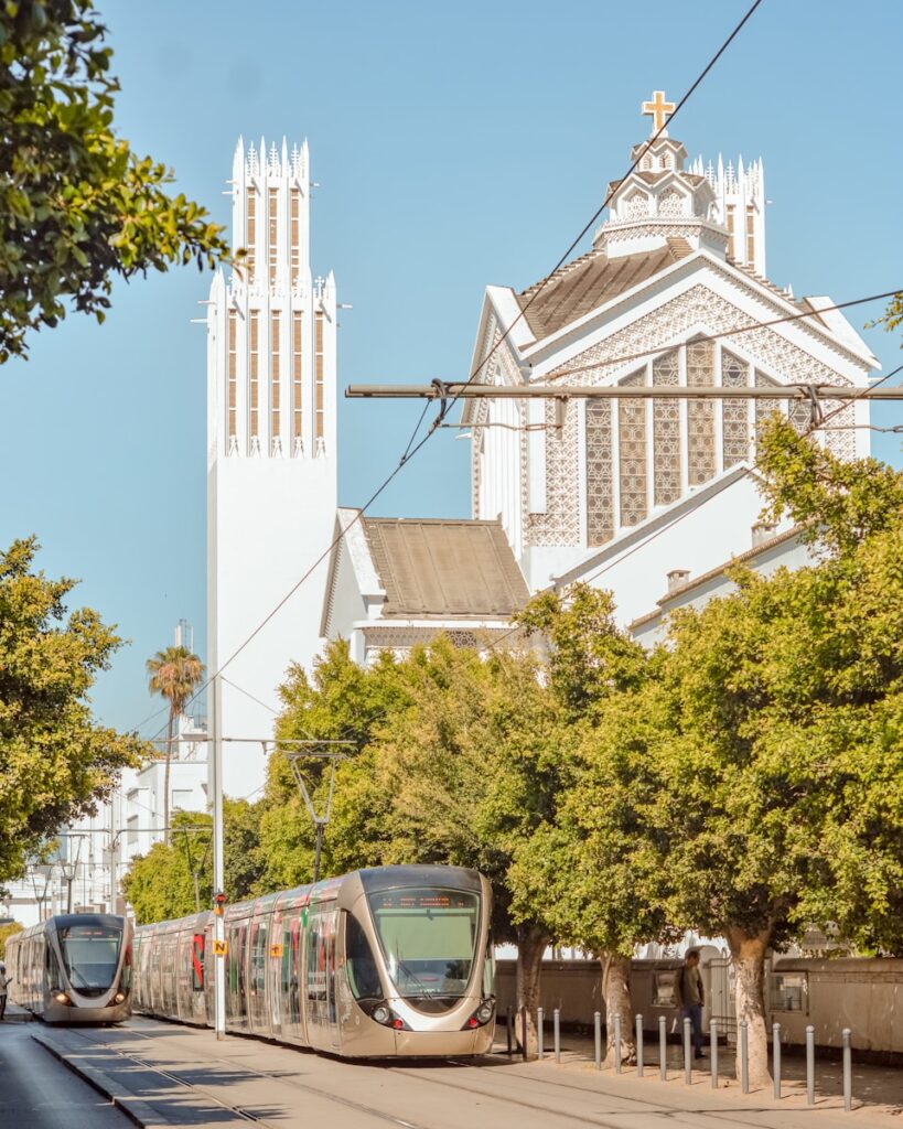 a train on the tracks in front of a church
