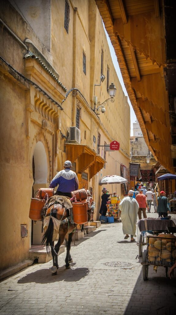 man riding horse on road, best places to visit in morocco