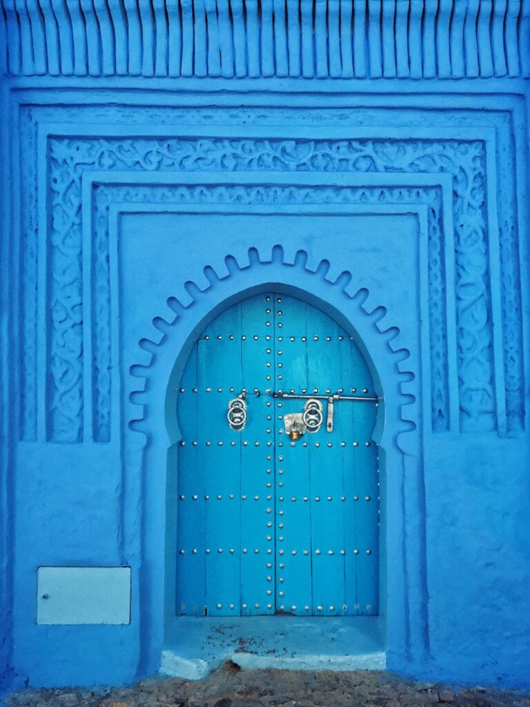 blue painted wall and door at daytime, rabat to chefchaouen