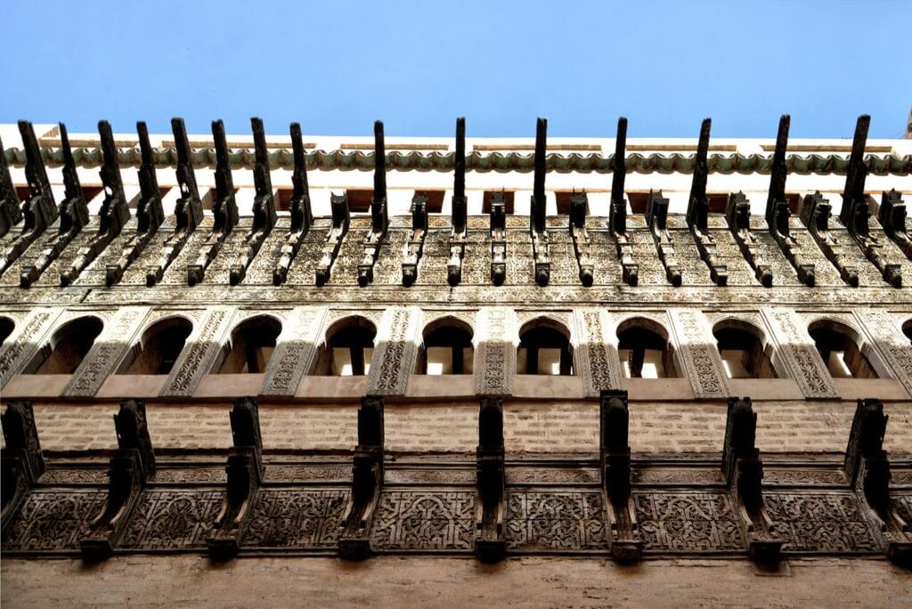 Detailed architecture of a historic building facade in Fès, showcasing intricate carvings.