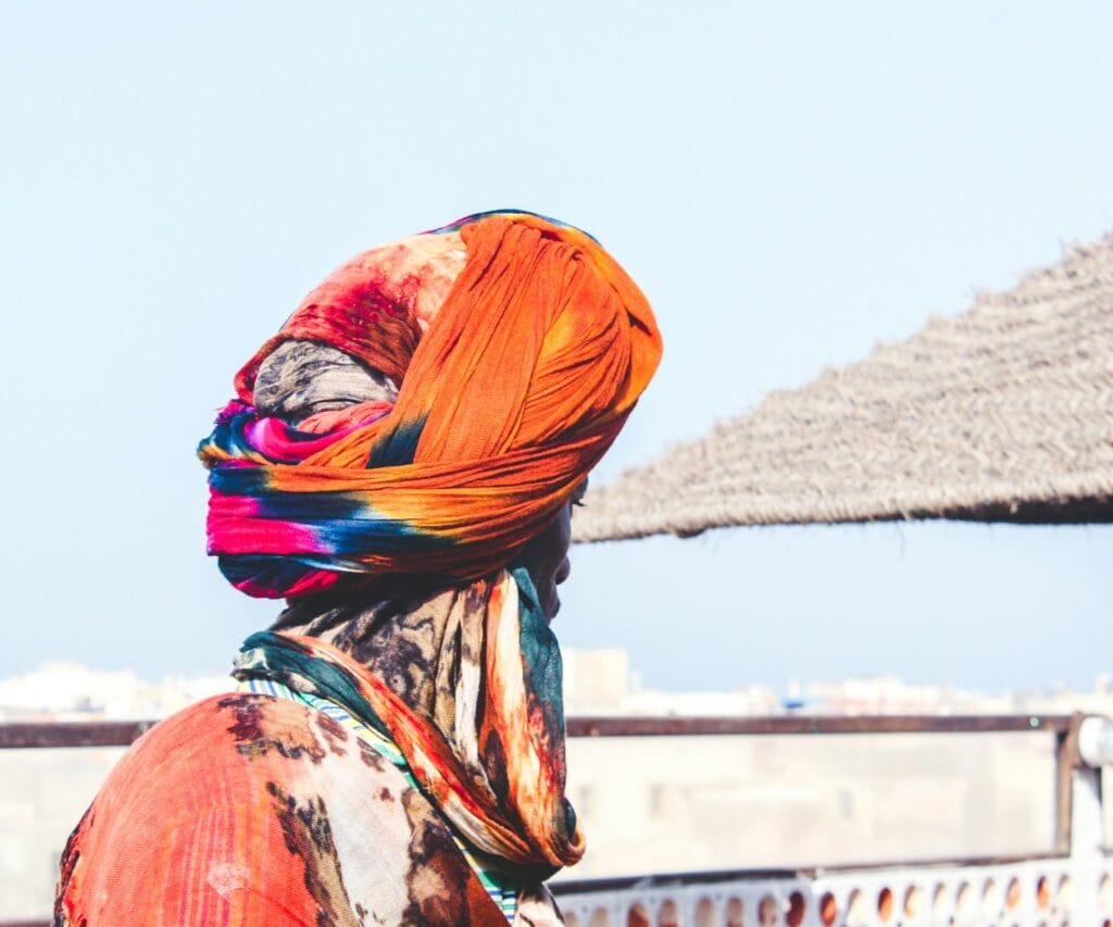 man wearing orange and pink turban, Headscarf in Morocco