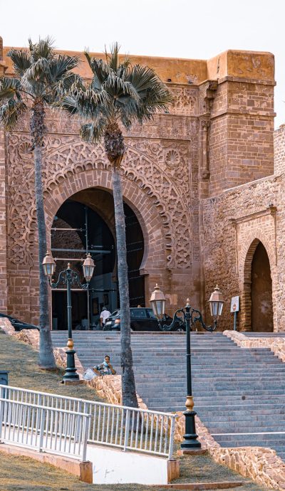 Stunning view of Kasbah of the Udayas entrance in Rabat, Morocco, with palm trees and historical architecture.Rabat North Africa
