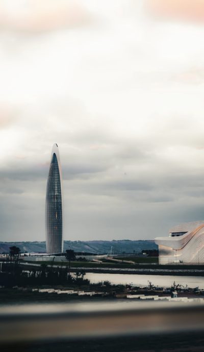 A large building with a very tall tower in the background