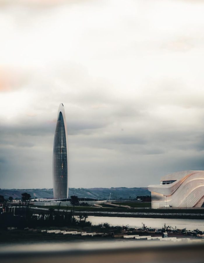 A large building with a very tall tower in the background,Rabat North Africa