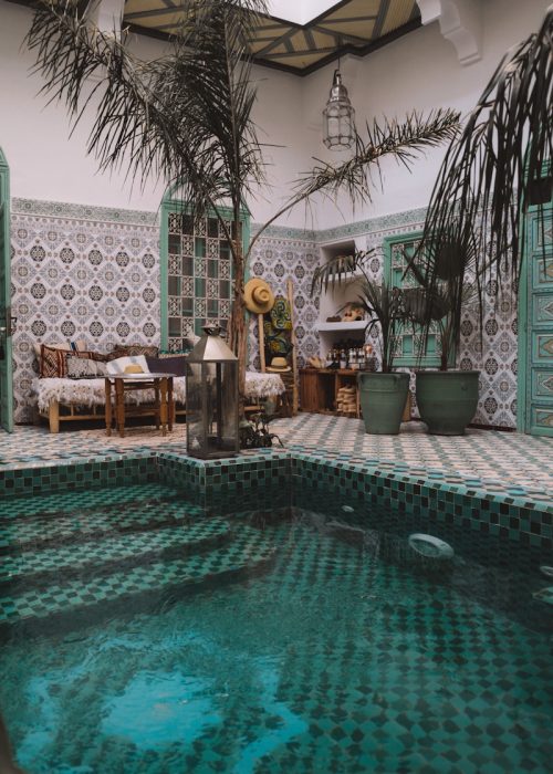 ground pool near wooden lounges