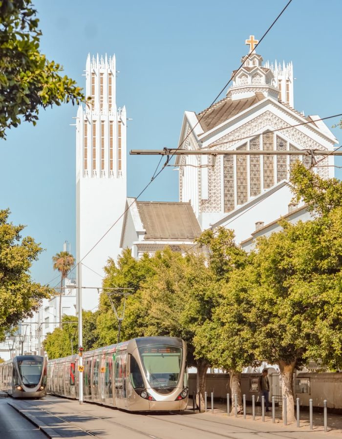a train on the tracks in front of a church,Rabat North Africa