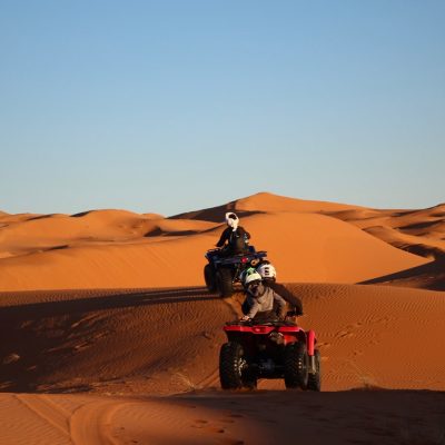 man riding atv on desert during daytime