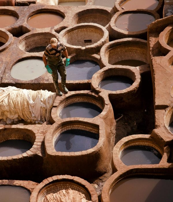 Morocco Tours for Seniors: Safe, Scenic & Culturally Rich Travel Options 3 Man working in traditional Moroccan tannery pits, showcasing the leather tanning process.morocco tours for seniors