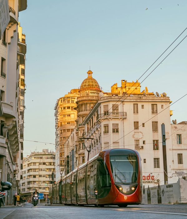 Casablanca Morocco: Ultimate Travel Guide for First-Time Visitors 3 A modern tram navigating the streets of Casablanca, Morocco against a backdrop of historic architecture.casablanca morocco