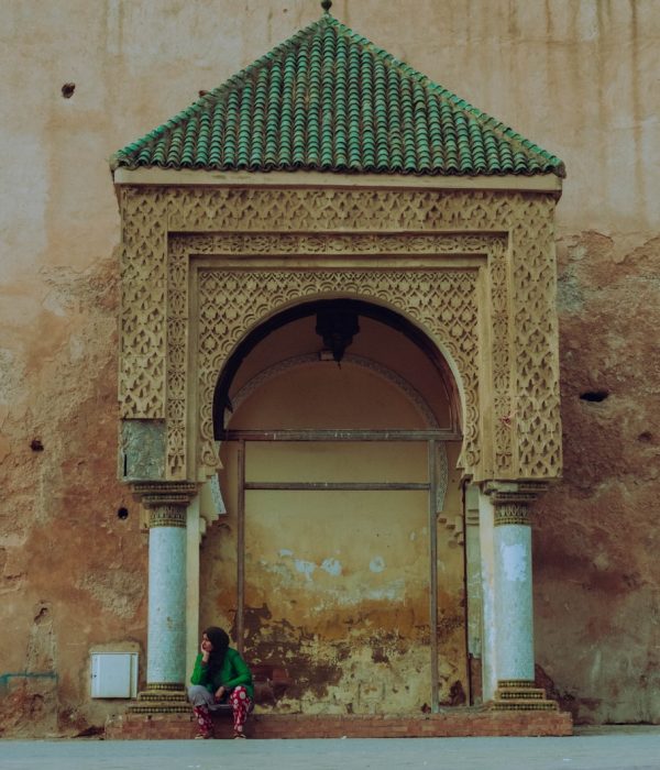 Getting Around Morocco: Your Friend's Guide to Not Getting Lost (or Ripped Off!) 2 a person and a child sitting in front of a door