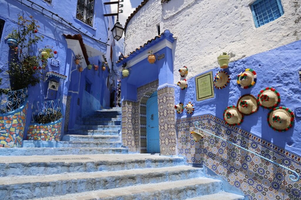 Explore the captivating blue streets of Chefchaouen, adorned with colorful pottery and traditional tiles.weather in morocco december