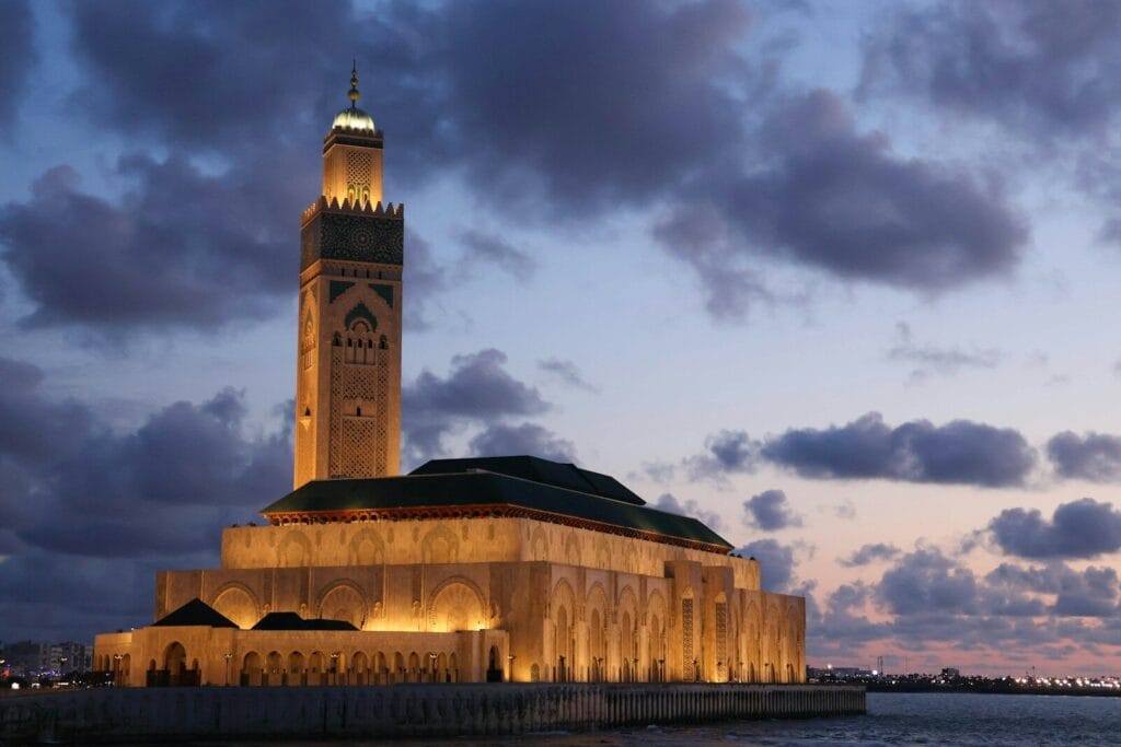a tall tower with a clock on top of it.Casablanca To Marrakech