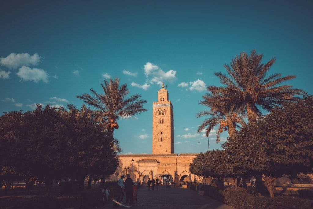 a tall clock tower towering over a city.Casablanca To Marrakech