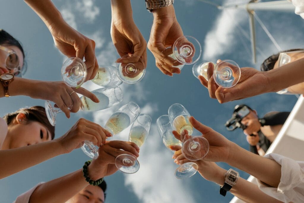 people holding clear glass bottles during daytime.alcohol in morocco