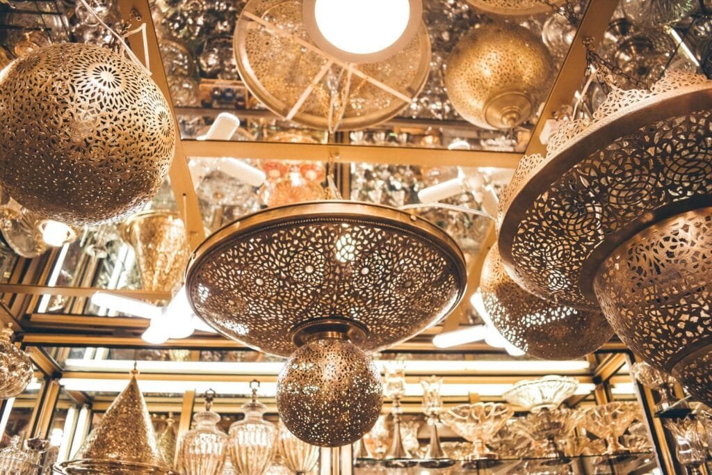 Intricate Moroccan lanterns hanging in a Fes interior design shop, showcasing traditional artisan craftsmanship.lanterns in morocco