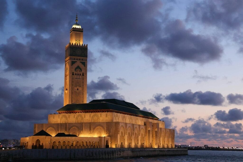 a tall tower with a clock on top of it.Marrakech Casablanca distance
